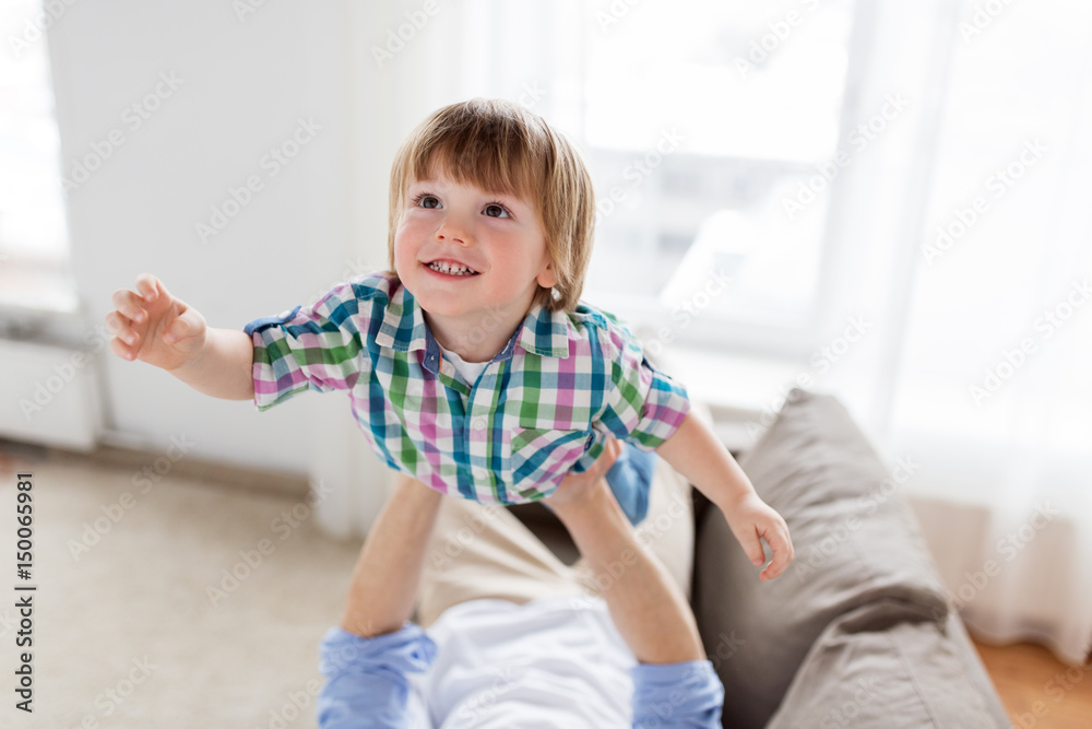 father hands holding happy little boy at home father hands holding happy little boy at home