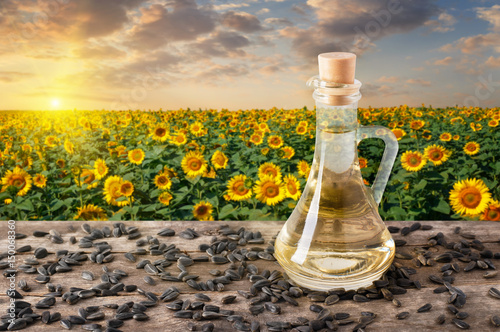 sunflower oil with sunflower field on sunset