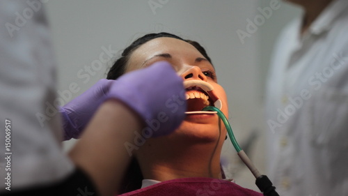 Girl corrects teeth in the dental office