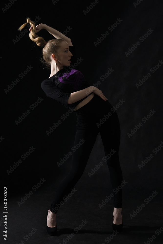 Vogue dancer posing on dark background