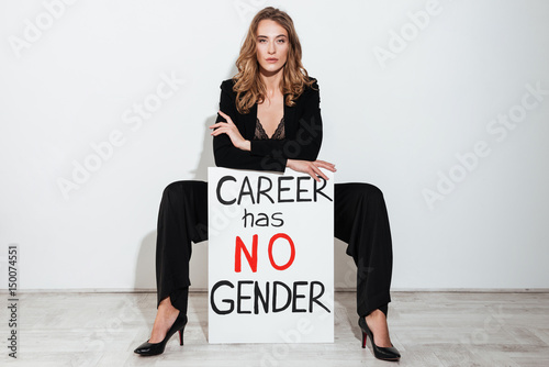 Fotografie Woman holding blank with text about career gender.