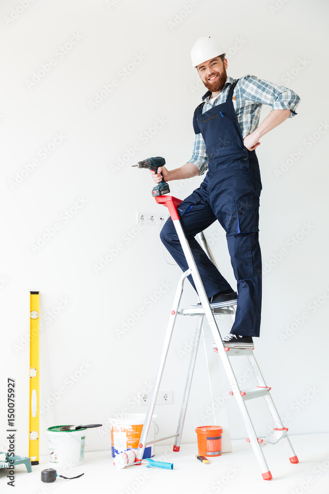 Happy man builder standing in new flat make repair Happy man builder standing in new flat make repair