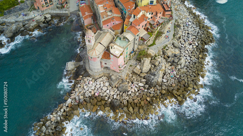 Aerial video shooting with drone on Tellaro, famous Ligurian village near the Cinqueterre, small colored houses built on the cliff by the sea