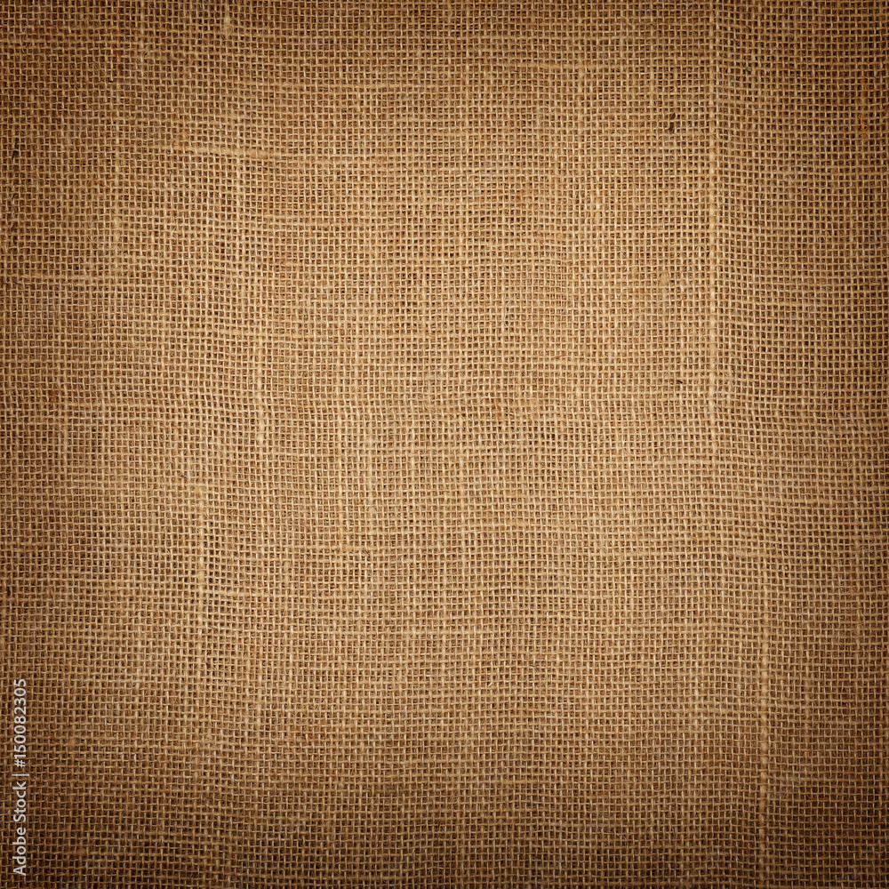 Fototapeta premium Brown burlap jute canvas background with shade
