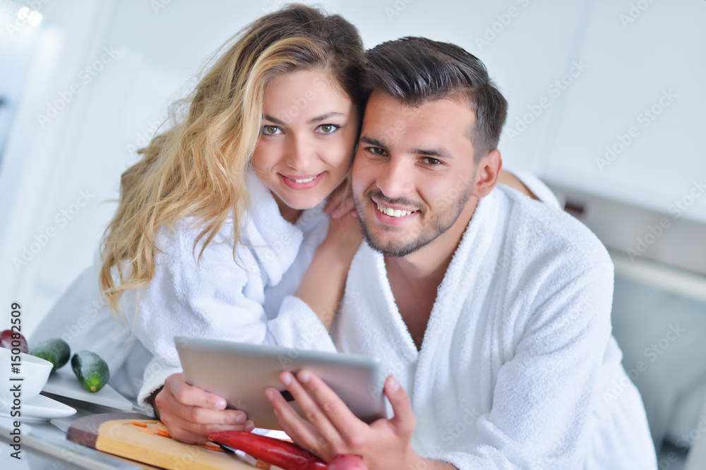 Happy couple cooking breakfast together in the kitchen Happy couple cooking breakfast together in the kitchen