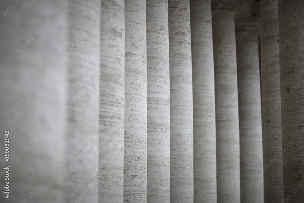 A row of columns near an ancient architectural structure A row of columns near an ancient architectural structure
