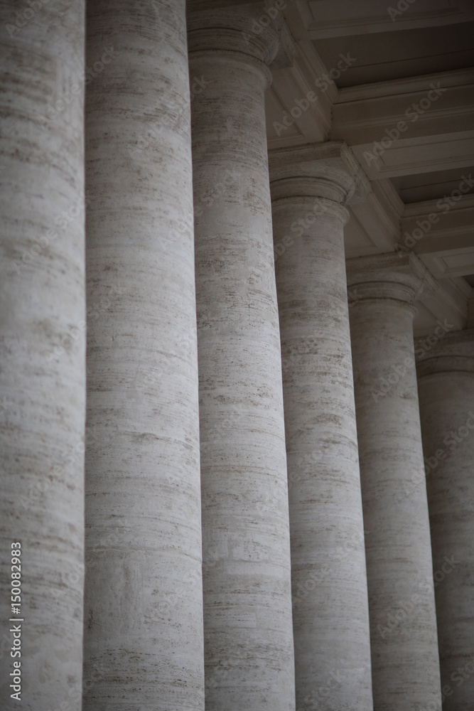 A row of columns near an ancient architectural structure