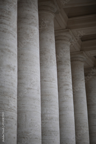 A row of columns near an ancient architectural structure