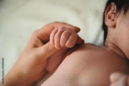 Toddler's hand in mother's hand