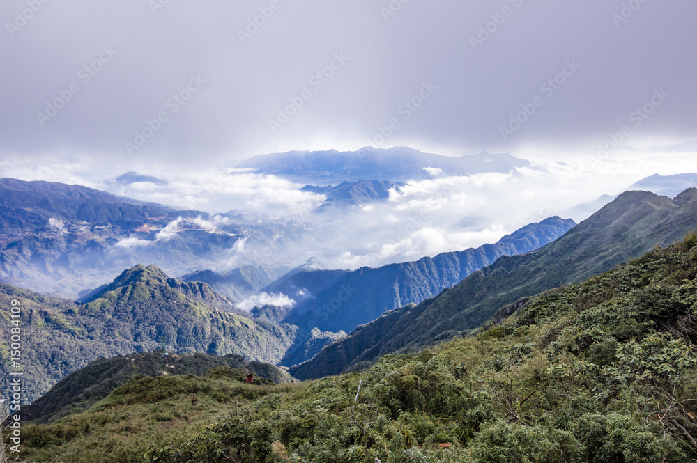 Valley covered with clouds. View from Fansipan - the highest mountain in Indochina located in Sapa, Hoang Lien Son mountain range, Lao Cai Province, Vietnam
