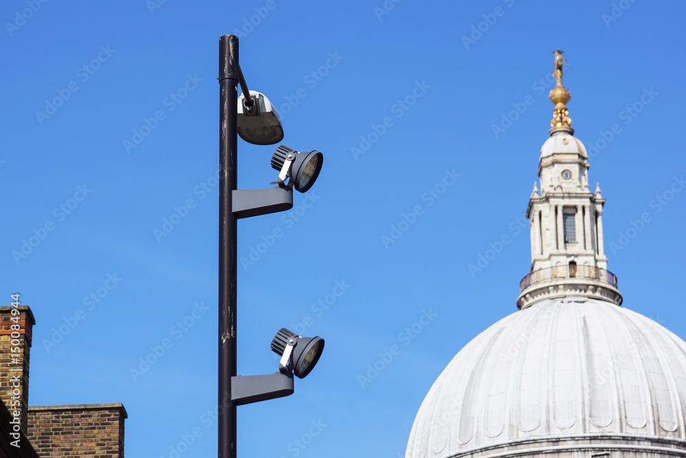 urban Pillar spotlights high on the blue sky at London city urban Pillar spotlights high on the blue sky at London city
