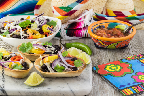 Mini taco boats with black beans and vegetables.