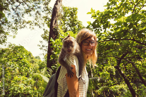 Photography Cute girl with monkey on her shoulder.