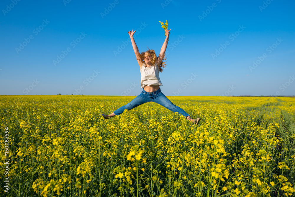 Joyful young woman, blonde jumping and having fun in a field Joyful young woman, blonde jumping and having fun in a field