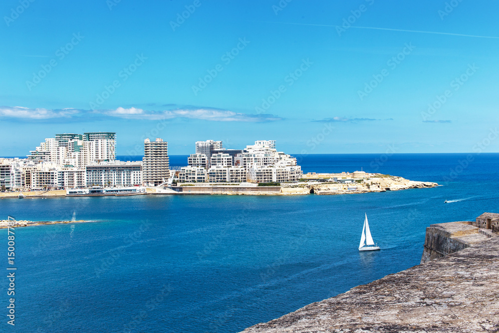 Tigne point with bay and sailboat, Malta, EU