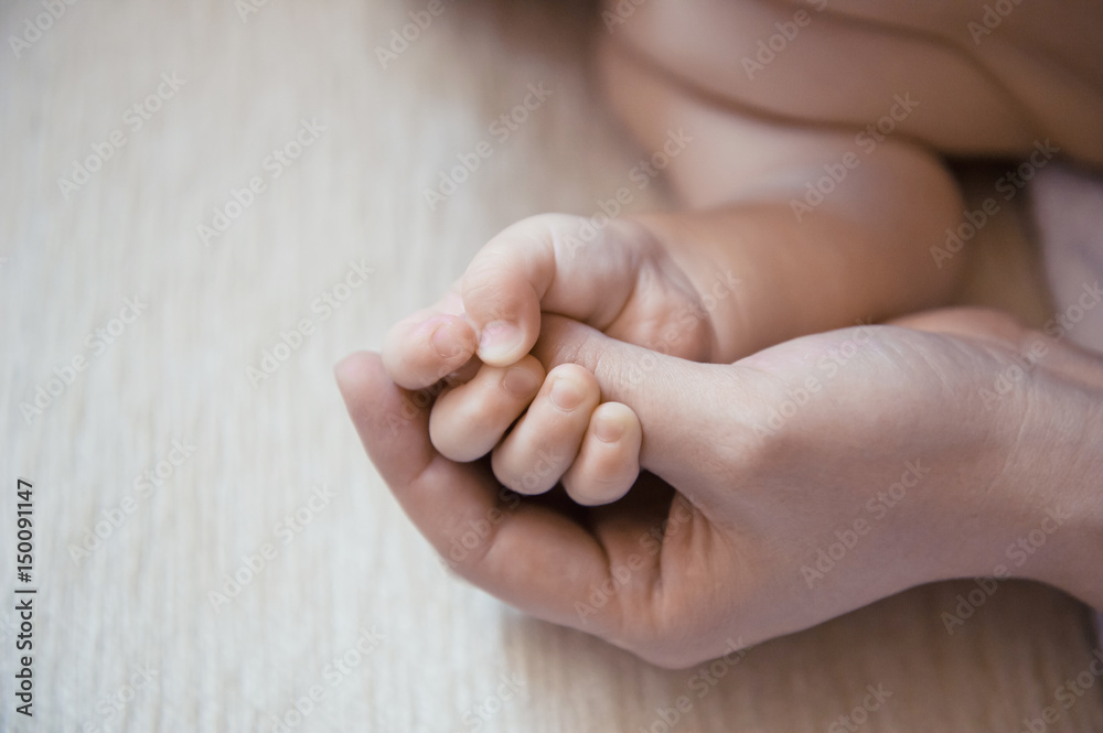 Toddler's feet in mother's hand