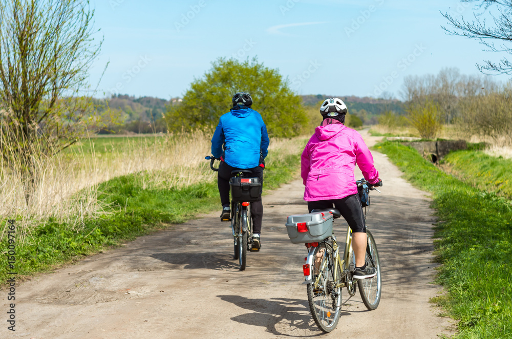 Fototapeta premium Older people ride a bike in the park