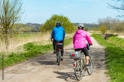Older people ride a bike in the park