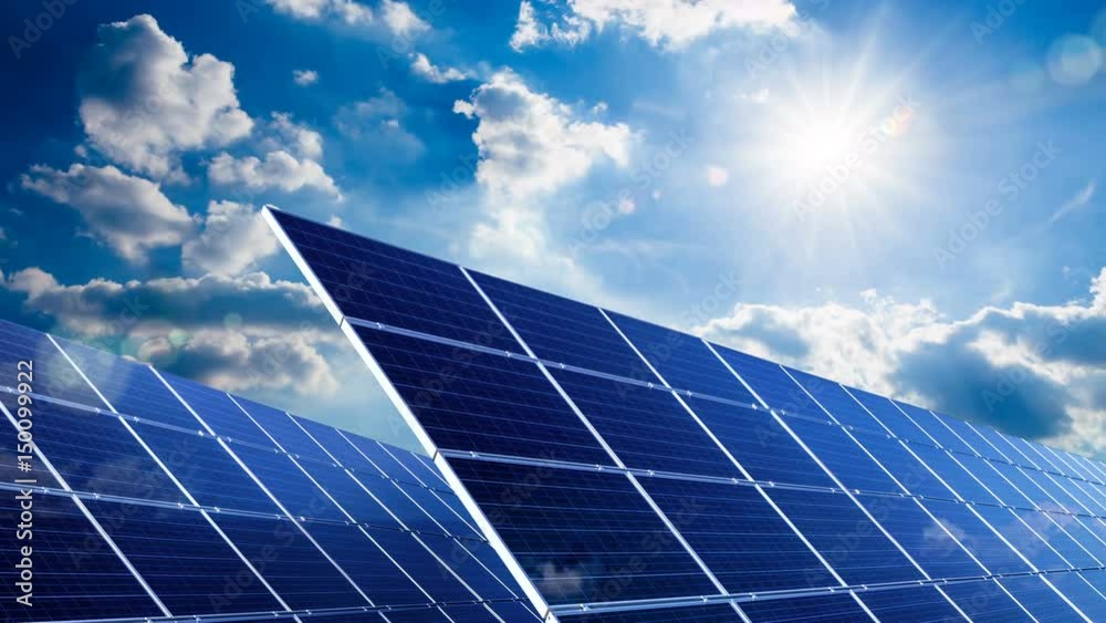 Time lapse footage of two large solar panels under the blue sky and the bright sun, with white clouds gently passing by