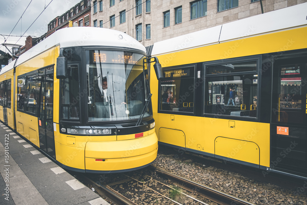 Berlin city tram, electric train on the street at Warschauerstr. in Berlin - obrazy, fototapety, plakaty 