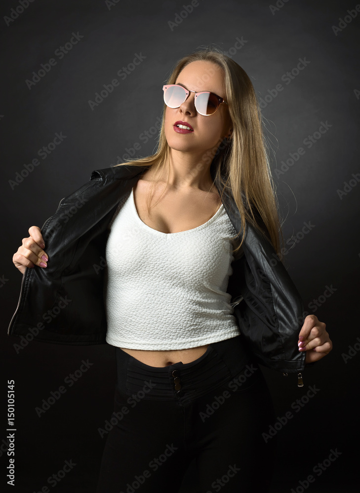 Beautiful woman in black leather jacket and sunglasses . Beautiful woman in black leather jacket and sunglasses .