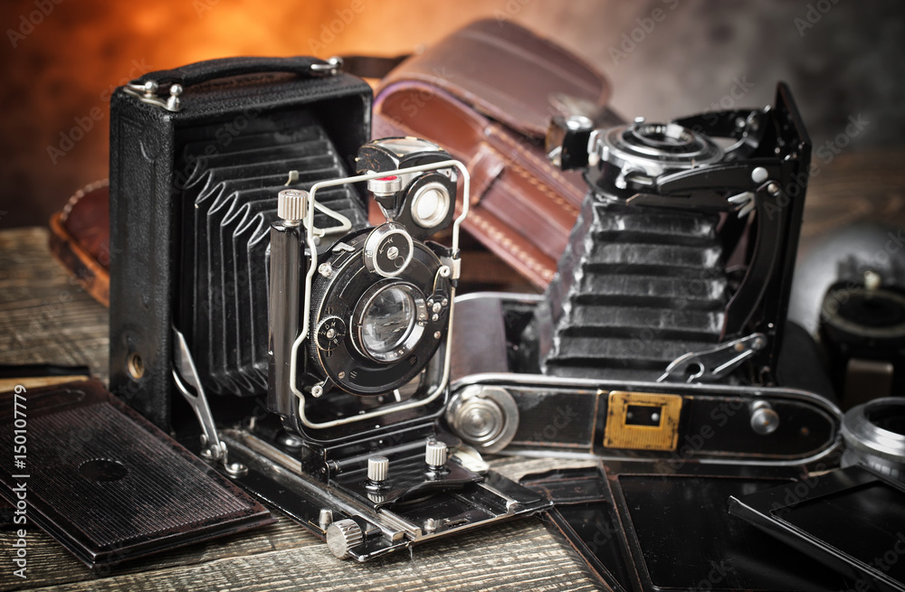 Old camera on an old background on a close-up table Old camera on an old background on a close-up table