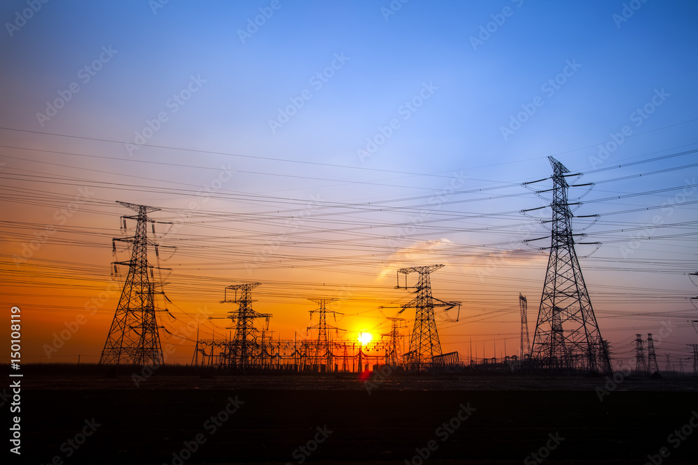 The silhouette of the evening electricity transmission pylon