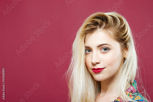 Portrait of Sensual Blonde in Colorful Shirt Looking at the Camera on Pink Background. Amazing Girl is Posing in Studio.