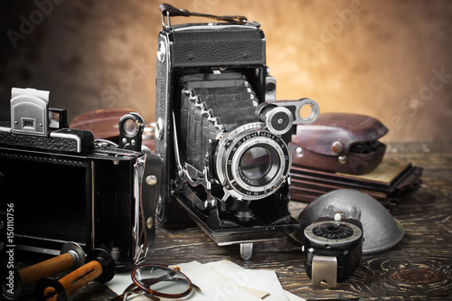 Old camera on an old background on a close-up table