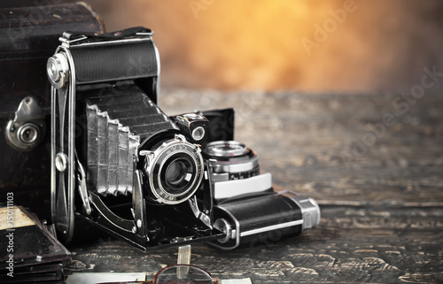 Old camera on an old background on a close-up table photo