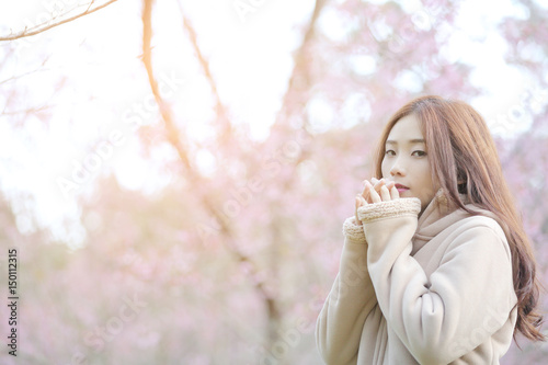 Asian Woman with cherry blossom nature background