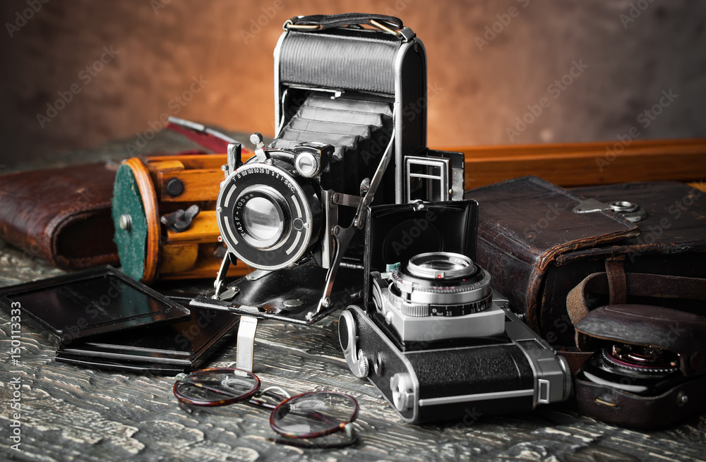 Old camera on an old background on a close-up table