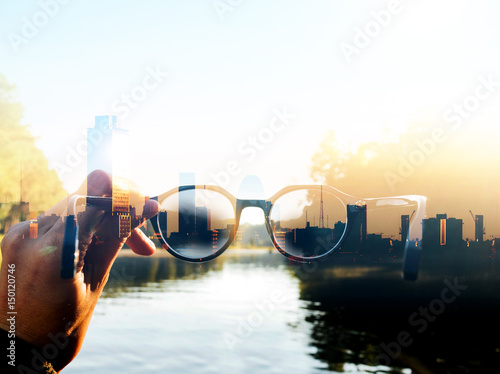 Obraz na płótnie Double exposure image of Hand-held glasses scene is Cityscape focus, Business vision w salonie