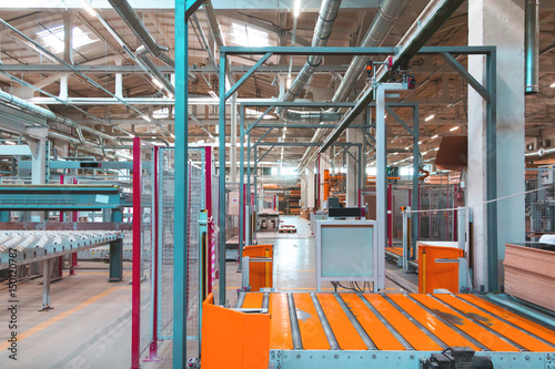 Piece of typical production plant interior with quards, platforms, piping, tubing, workbenches. photo