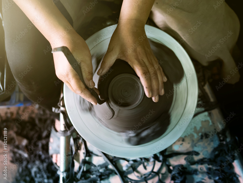 Potter making a clay pot, handmade, selective focus