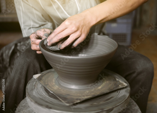 Potter making a clay pot, handmade, selective focus