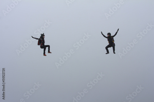 Two skydiver girls in the cloud