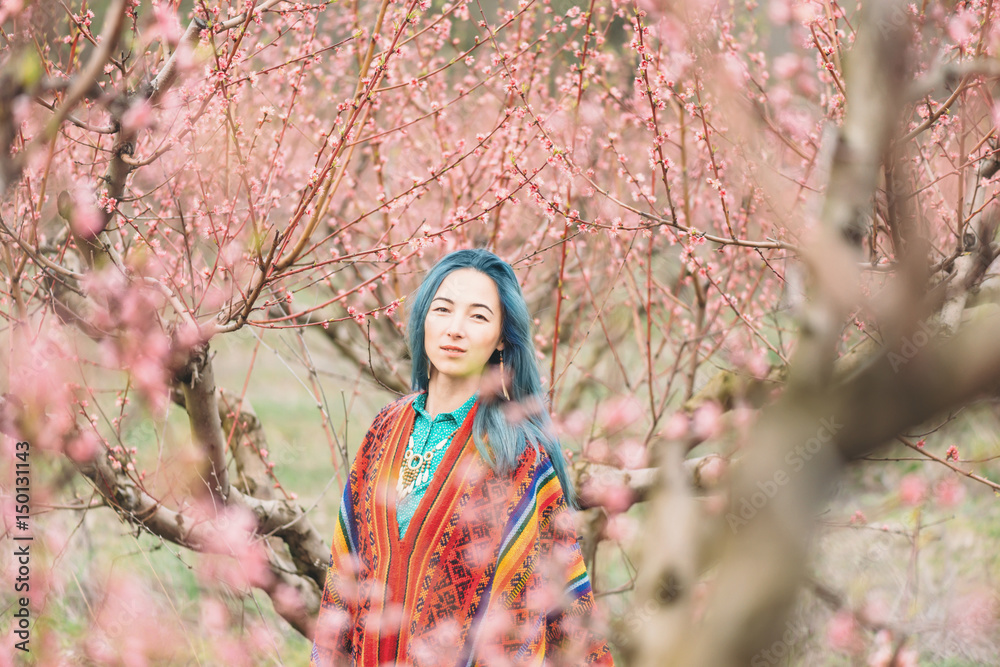 Beautiful girl walking in flowering garden. Beautiful girl walking in flowering garden.