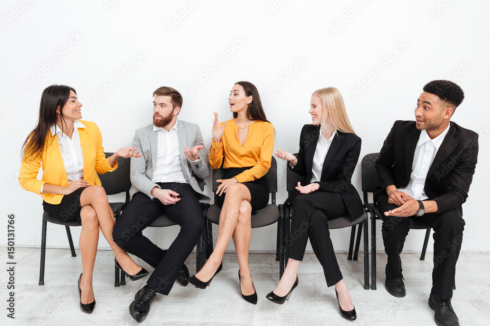 Colleagues sitting in office talking with each other