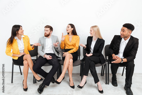 Colleagues sitting in office talking with each other
