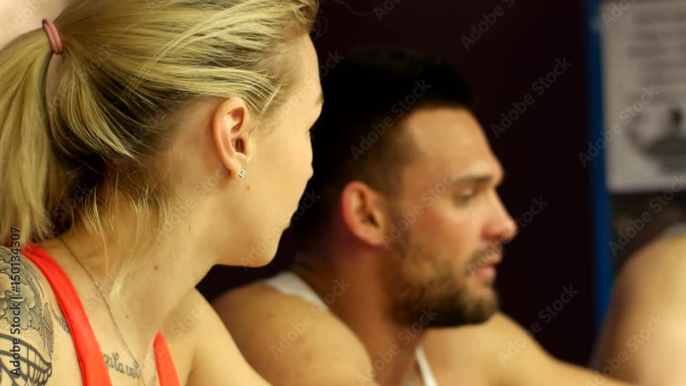 Three coaches are chatting at the bar in the fitness club Three coaches are chatting at the bar in the fitness club