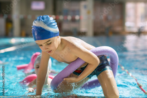happy children kids group at swimming pool class learning to swim © FS-Stock