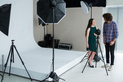 Canvas Print Photographer and model reviewing captured photos