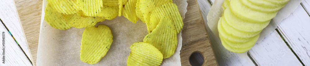 Horizontal bakground of potato chips on a table