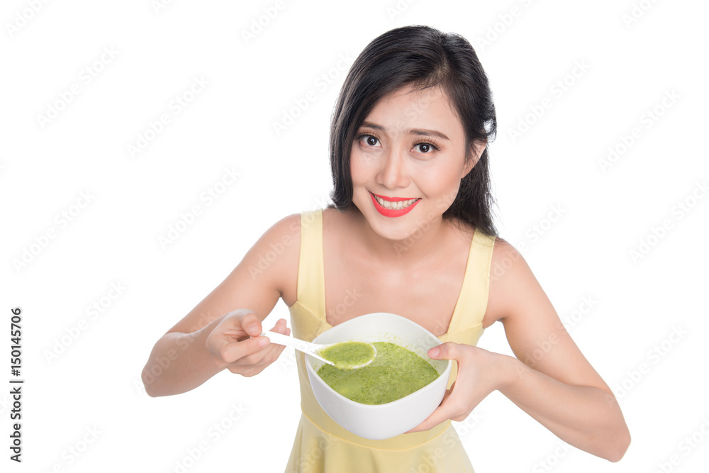 Portrait of asian woman eating/holding a plate of green vegetables soup Portrait of asian woman eating/holding a plate of green vegetables soup