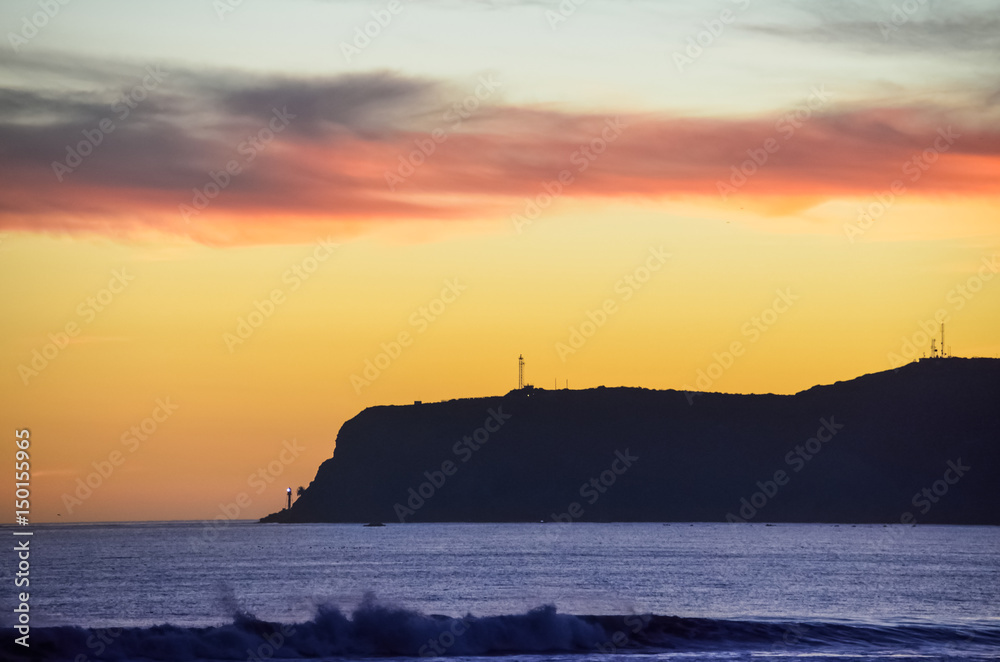 Colorful sunset on Coronado island with silhouettes of Cabrillo National Monument in San Diego, California