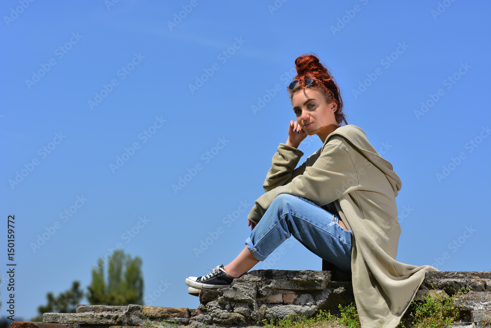 Fototapeta premium Beautiful redhead with blue eyes posing outdoor