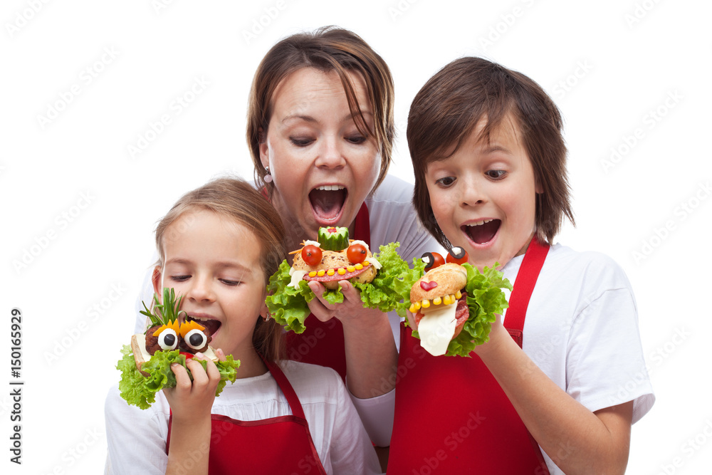 Kids and woman taking a bite of funny creatures sandwiches Kids and woman taking a bite of funny creatures sandwiches
