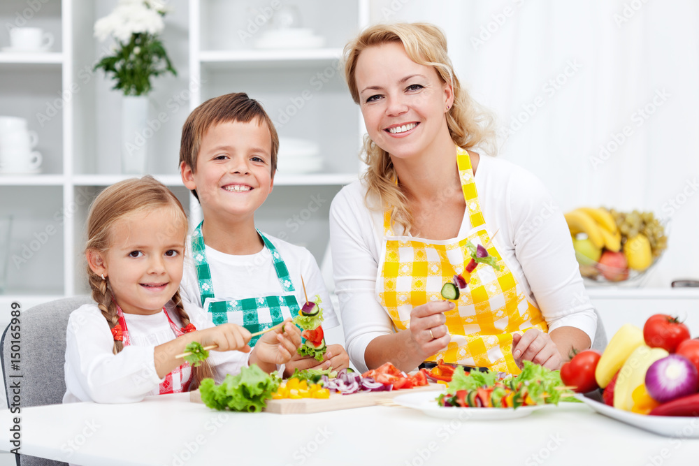 Young kids with their mother in the kitchen Young kids with their mother in the kitchen