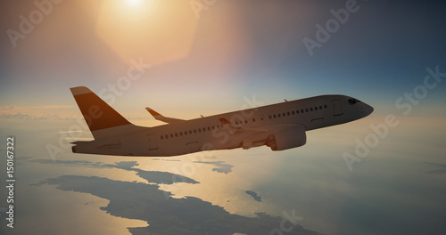Airplane in flight over sea during sunset